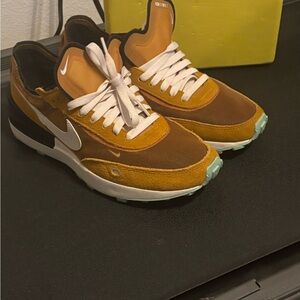 Nike  women, mustard,gold with mesh   White  shoe strings. Colorful soles